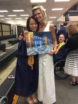 An Yuhua and her Rep Sally with a photo from Graudation and a painting for Sally from An